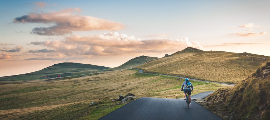 cyclists on a road amidst rolling hills - who would benefit from a glucosamine supplement